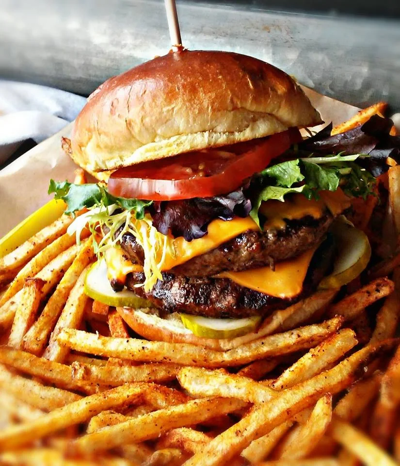 A stacked specialty burger from the Flat Iron Tap kitchen